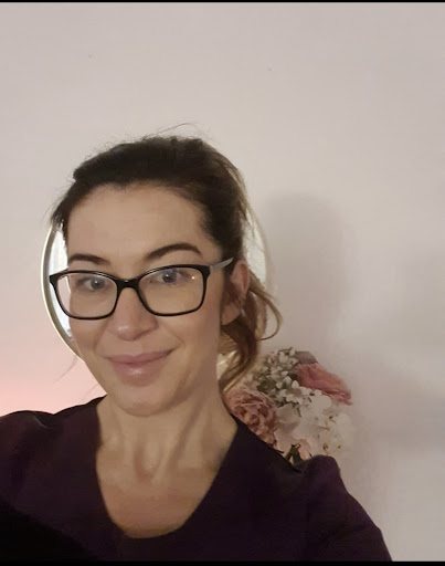 Lisa, smiling, in her purple tunic